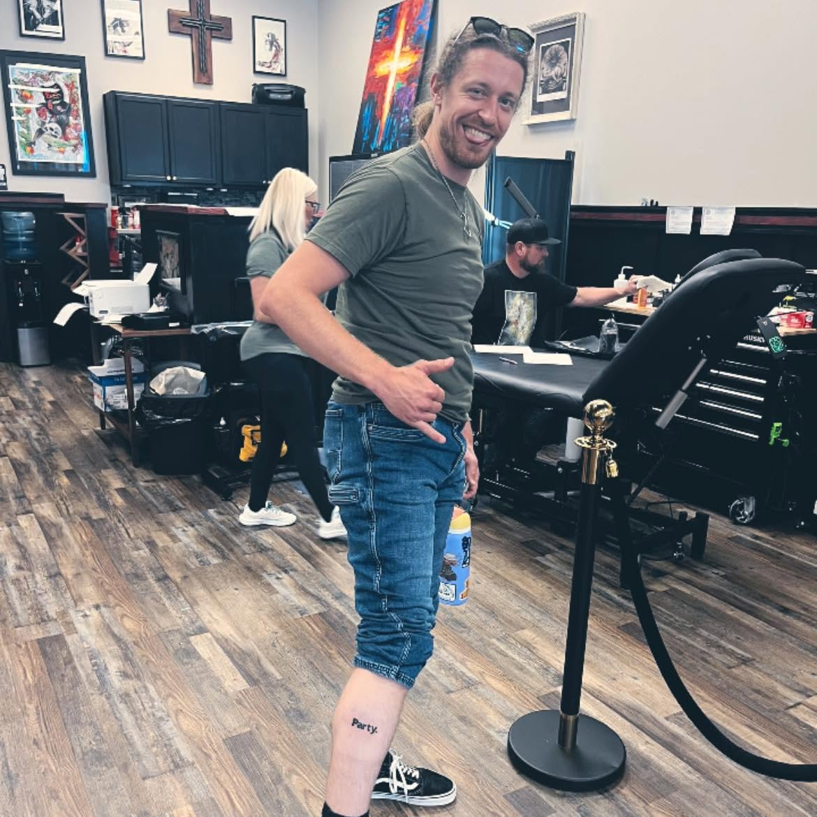 A smiling friend in a tattoo studio